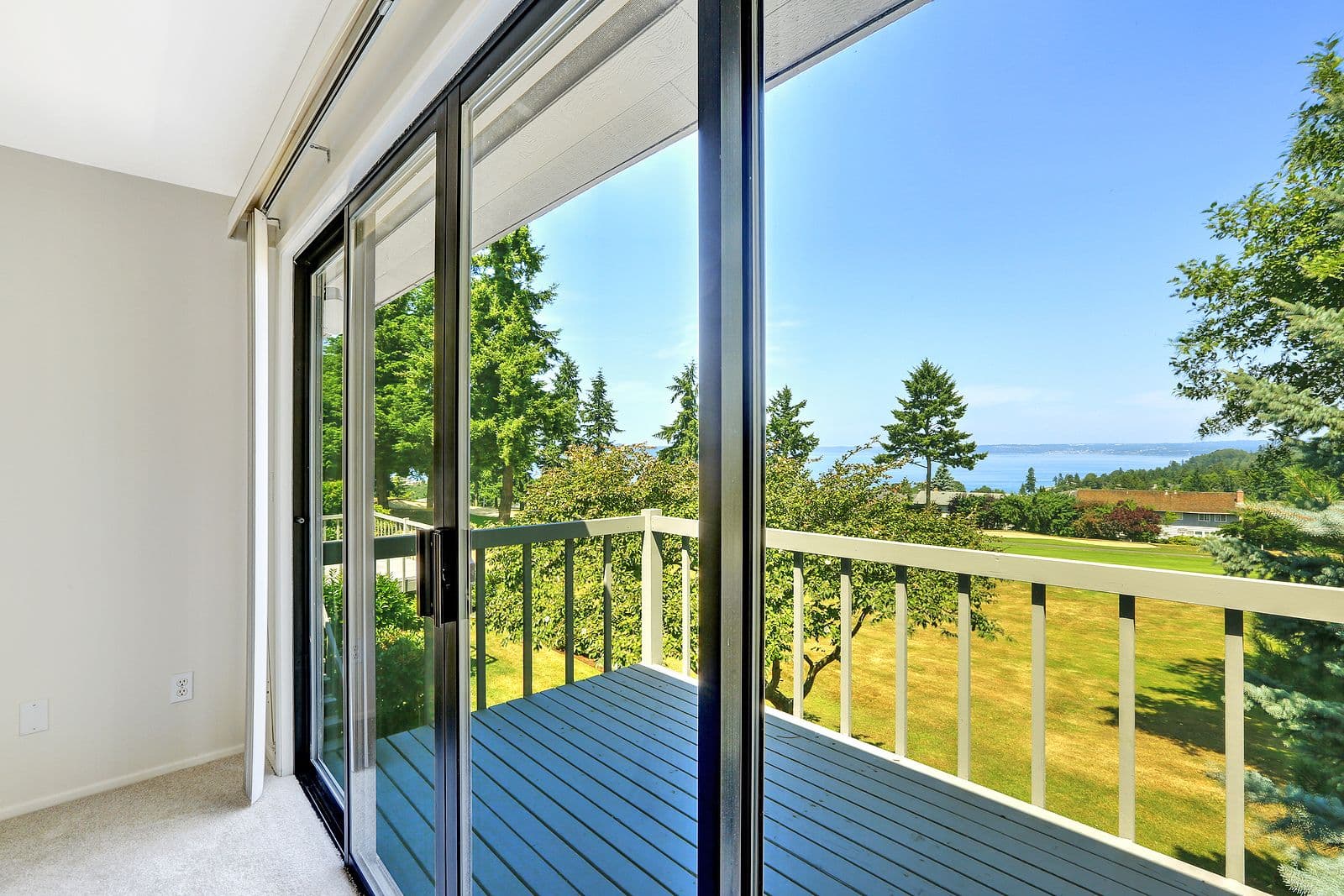 House with water view. Walkout deck with glass slide door